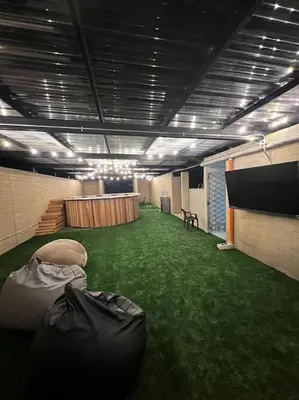 a large room with green grass and a stage at Lindo apartamento en Laureles con piscina 501 in Medellín