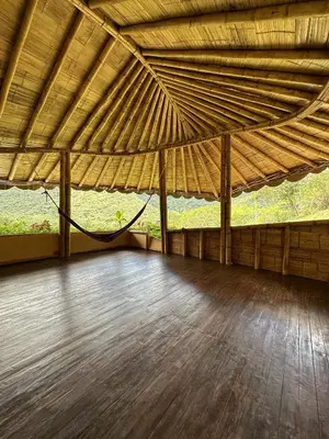 a large room with a hammock under a large roof at Mandi Wasi - Alojamiento Compartido in San Rafael