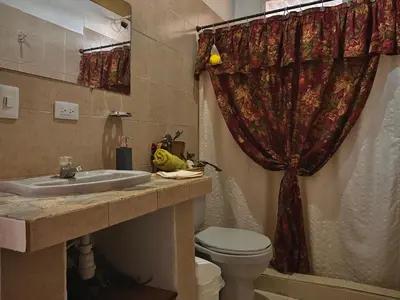 a bathroom with a sink and a toilet and a shower at Casa Amaru in Guarne