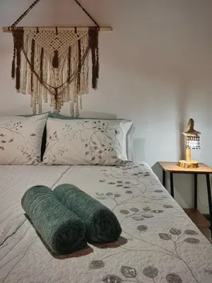 a bed with two green towels on top of it at Casa Amaru in Guarne