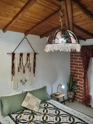 a bedroom with a bed and a chandelier at Casa Amaru in Guarne