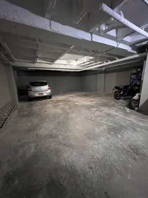 a parking garage with a car parked in it at Espacioso apartamento con piscina en Laureles 201 in Medellín