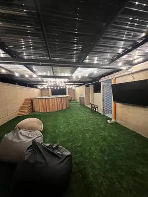 a large room with green grass and a stage at Espacioso apartamento con piscina en Laureles 201 in Medellín