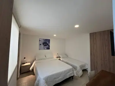 a bedroom with two beds in a room at Apartaestudio moderno cerca al cable in Manizales