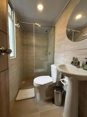 a bathroom with a toilet and a sink and a shower at Apartaestudio moderno cerca al cable in Manizales