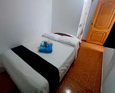 a room with a bed with a blue bag on it at Hotel El Mirador in San Carlos