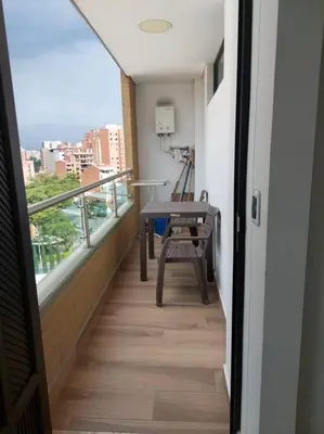 a room with a balcony with a table and a chair at Apto tipo Loft en Laureles Nutibara Increíble Vista in Medellín