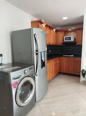 a kitchen with a refrigerator and a washing machine at Apto tipo Loft en Laureles Nutibara Increíble Vista in Medellín