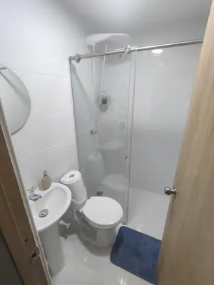 a bathroom with a shower and a toilet and a sink at Apartaestudio la 70, estadio in Medellín