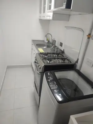 a kitchen with a stove and a sink at Apartaestudio la 70, estadio in Medellín
