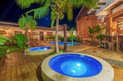 a large blue pool in a backyard with palm trees at Casa Linaje Hotel Boutique -Cauca Viejo- Mayores de 10 años in Jericó