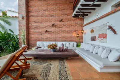 a patio with a bench and a brick wall at Casa Linaje Hotel Boutique -Cauca Viejo- Mayores de 10 años in Jericó