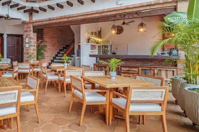a restaurant with wooden tables and chairs at Casa Linaje Hotel Boutique -Cauca Viejo- Mayores de 10 años in Jericó