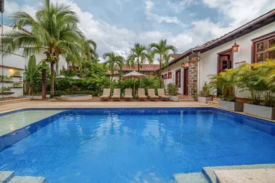a swimming pool in a house with palm trees at Casa Linaje Hotel Boutique -Cauca Viejo- Mayores de 10 años in Jericó