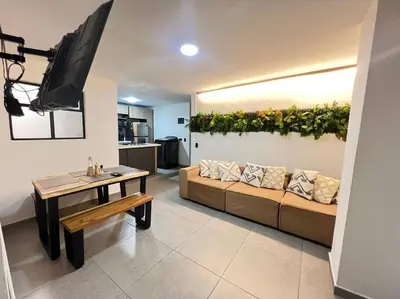 a living room with a couch and a table at Elegante apto Laureles Estadio in Medellín