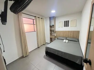 a bedroom with a bed with two towels on it at Elegante apto Laureles Estadio in Medellín