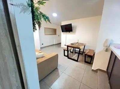 a living room with a couch and a table at Elegante apto Laureles Estadio in Medellín