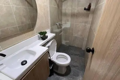 a bathroom with a toilet and a sink and a shower at Elegante apto Laureles Estadio in Medellín