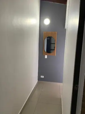 a hallway with a mirror on a blue wall at S3 CÓMODO APARTAMENTO 3 HABI 3 BAÑOS EN LAURELES ESTADIo in Medellín