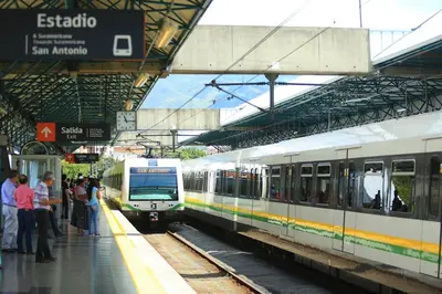 two trains at a train station with people waiting on the platform at S3 CÓMODO APARTAMENTO 3 HABI 3 BAÑOS EN LAURELES ESTADIo in Medellín