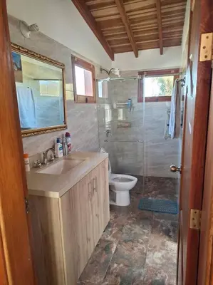 a bathroom with a shower and a sink and a toilet at Casa San Miguel Santa Elena in Medellín