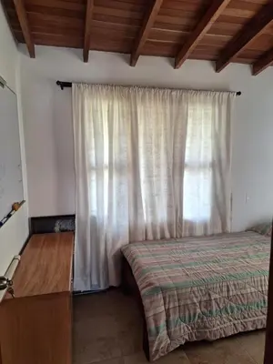 a bedroom with a bed and a large window at Casa San Miguel Santa Elena in Medellín