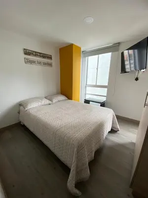 a bedroom with a bed and a window at Edificio Urban Frente universidad Autónoma in Manizales