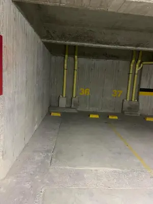 an empty parking garage with yellow piping in it at Edificio Urban Frente universidad Autónoma in Manizales