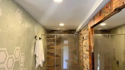 a bathroom with a shower and a glass shower stall at Autenthico Sajonia Hotel Aeropuerto in Rionegro