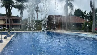 a fountain in the middle of a swimming pool at Autenthico Sajonia Hotel Aeropuerto in Rionegro