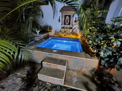 a swimming pool in the middle of a garden at Casa Premium Las Palmas San Jeronimo in San Jerónimo