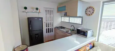 a kitchen with a black refrigerator and a sink at Casa Premium Las Palmas San Jeronimo in San Jerónimo