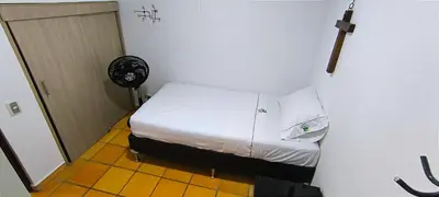 a small room with a bed and a fan at Casa Premium Las Palmas San Jeronimo in San Jerónimo