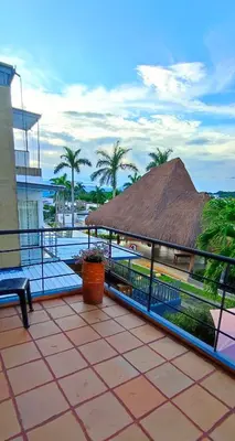 a patio with a thatch roof and a swimming pool at Casa Premium Las Palmas San Jeronimo in San Jerónimo