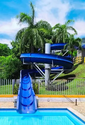 a blue water slide in a swimming pool at Casa Premium Las Palmas San Jeronimo in San Jerónimo