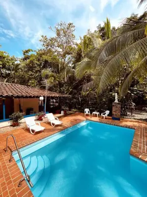 a swimming pool with chairs and a house at Paraiso del Cauca in Jericó