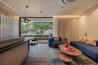 a living room with a blue couch and a table at Nock - Reserved Residences in Medellín