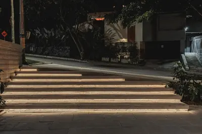 a set of stairs at night with lights on at Nock - Reserved Residences in Medellín
