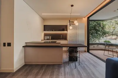 a kitchen and dining area with a large window at Nock - Reserved Residences in Medellín