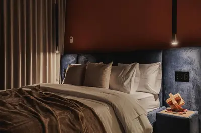 a bedroom with a large bed with a blue headboard at Nock - Reserved Residences in Medellín