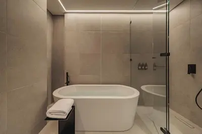a bathroom with a bath tub and a shower at Nock - Reserved Residences in Medellín