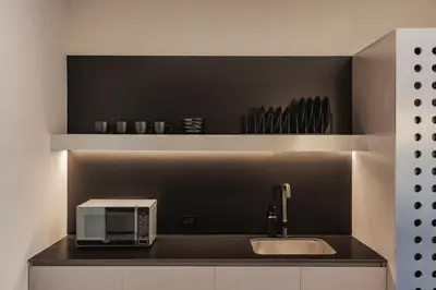 a kitchen counter with a microwave and a sink at Nock - Reserved Residences in Medellín