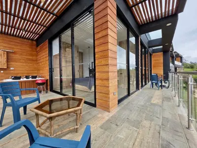 an outdoor patio with blue chairs and a table at Montecielo Lodge 41 - Jacuzzi y Vista Piedra Peñol in El Peñol