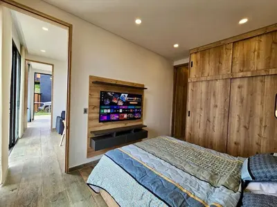 a bedroom with a bed and a flat screen tv at Montecielo Lodge 41 - Jacuzzi y Vista Piedra Peñol in El Peñol
