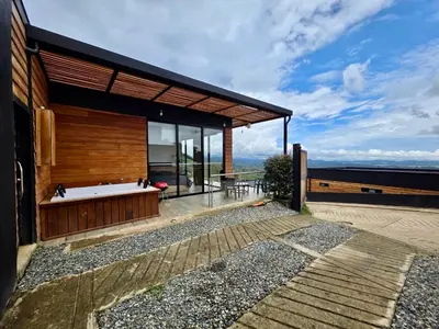 a modern house with a bath tub on a deck at Montecielo Lodge 41 - Jacuzzi y Vista Piedra Peñol in El Peñol
