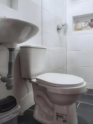 a bathroom with a white toilet and a sink at CASA ESTADIO MEDELLIN Apartamentos Turisticos renovados y modernos cerca al METRO - Barrio Laureles-Estadio in Medellín
