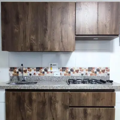 a kitchen with wooden cabinets and a sink at CASA ESTADIO MEDELLIN Apartamentos Turisticos renovados y modernos cerca al METRO - Barrio Laureles-Estadio in Medellín