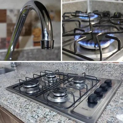 a stove top oven with a sink and a kitchen counter at CASA ESTADIO MEDELLIN Apartamentos Turisticos renovados y modernos cerca al METRO - Barrio Laureles-Estadio in Medellín