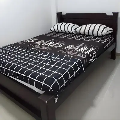 a black and white bed with pillows on it at CASA ESTADIO MEDELLIN Apartamentos Turisticos renovados y modernos cerca al METRO - Barrio Laureles-Estadio in Medellín