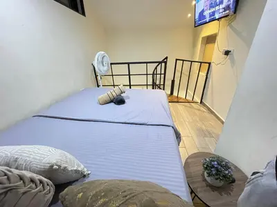 a bedroom with a bed and a tv in a room at Joes loft la70 laurles estadio Apt de 1Alcoba in Medellín
